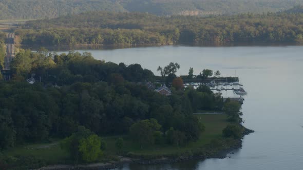 Aerial of green trees and a port on coast of Hudson river