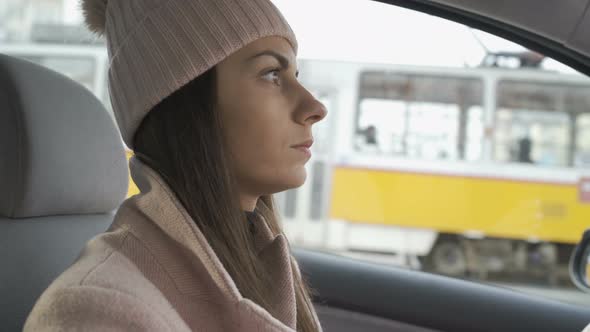 Young Woman Driver Driving in City Traffic