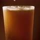 Pouring golden light beer into a rotating glass. - VideoHive Item for Sale