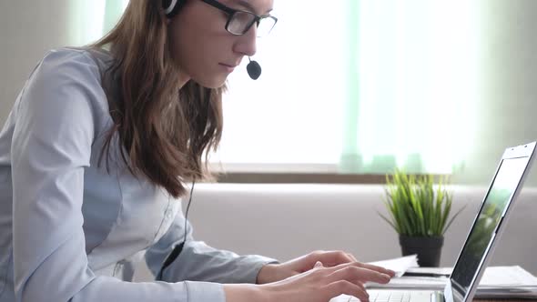 The Call Center Manager is Typing on a Laptop