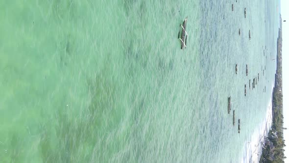 Vertical Video Boats in the Ocean Near the Coast of Zanzibar Tanzania Aerial View