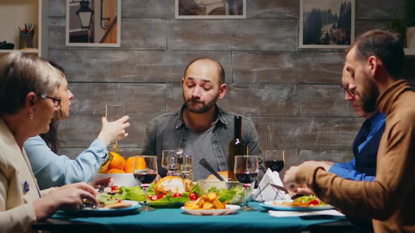 Husband and Wife Clinking a Glass of Red Wine