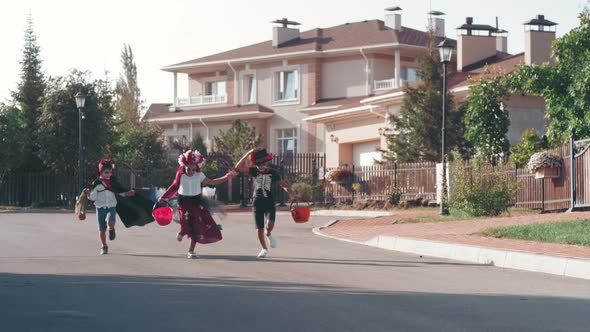 Excited Children in Halloween Costumes Running