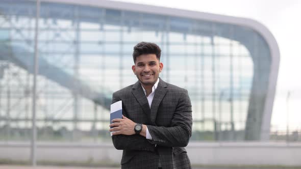 Handsome Businessman with Passport at Airport