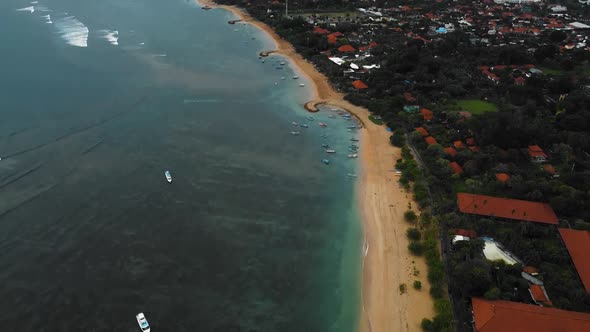 Beautiful cinematic Sanur beach, Bali drone footage with interesting landscape, fishing boats and ca