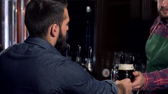 Unrecognizable Man Drinking Delicious Craft Beer at the Pub