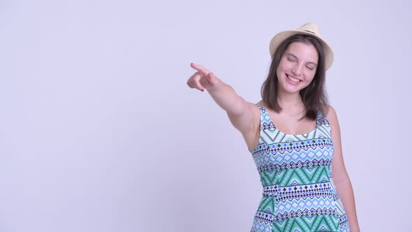 Happy Young Beautiful Tourist Woman Pointing Finger