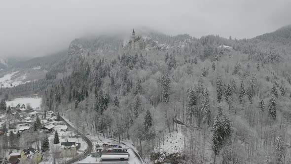 Aerial View Of Neuschwanstein getting altitude while flying towards to the castle