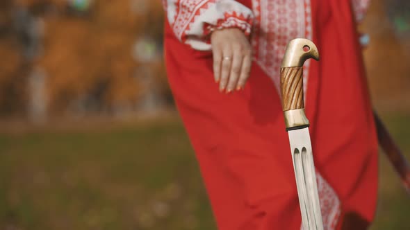 Feisty Woman Standing with Her Swords Crosswise