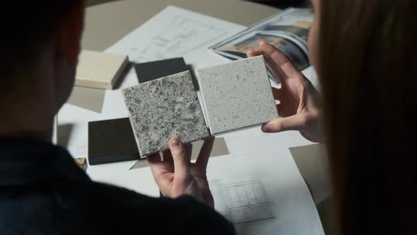 Man and Woman Choosing Material Samples Close Up. Team of Architects Discussing Quartz Materials