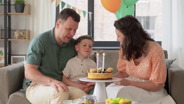 Happy Family with Birthday Cake at Home