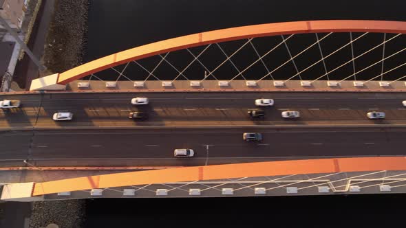 Cinematic aerial shot over Hastings bridge, Minnesota, as traffic crosses during the evening period