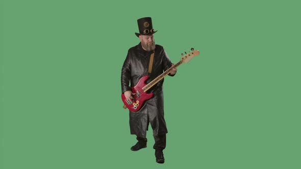 A Bearded Man in a Long Leather Coat and an Irishstyle Hat Plays the Red Guitar