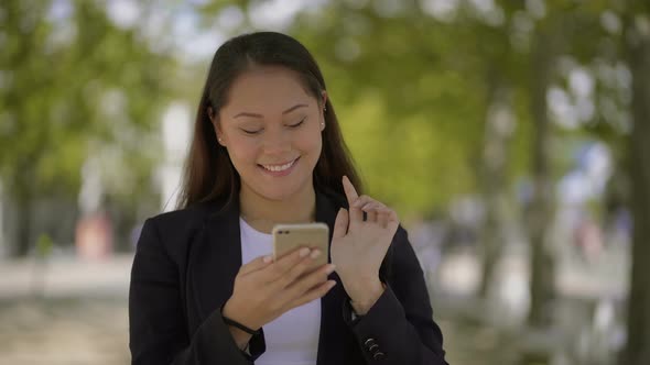 Girl Using Smartphone and Walking on Street