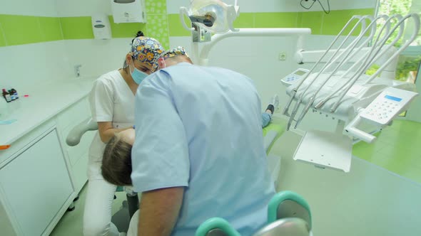 Nurse and dentist treating patient