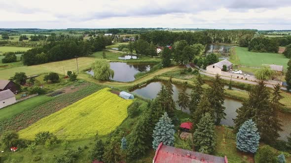 Aerial Drone Shot of Agricultural Fields in Small Village