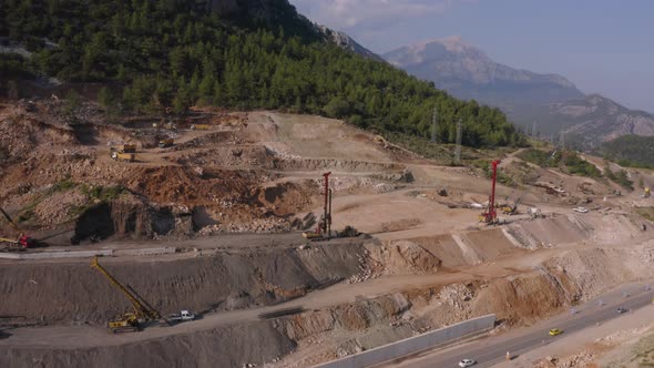 Beautiful Landscape View of Quarry with Heavy Machinery at Mountains