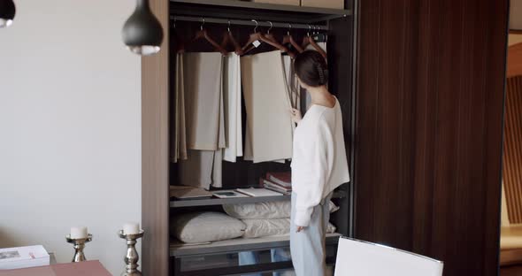 Young Woman Chooses Curtains in the Store