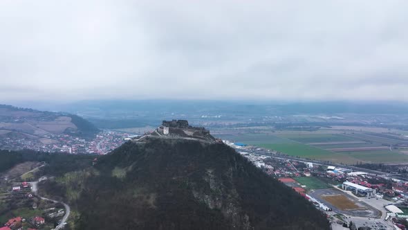 Stunning Aerial View of the Medieval Stone Fortress of Deva on a Cloudy Day