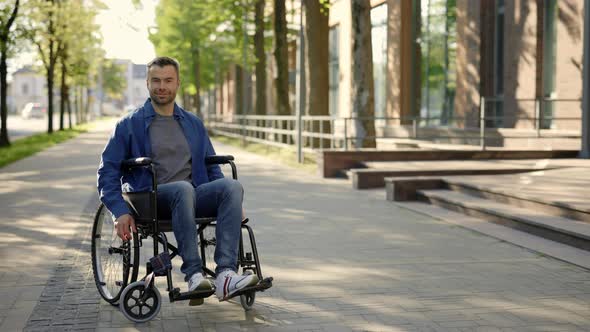 Portrait of the Happy Man on a Wheelchair Wearing Casual Clothes