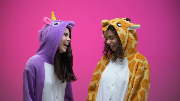 Funny Young Women Wearing Unicorn and Giraffe Pajamas, Laughing, Entertainment