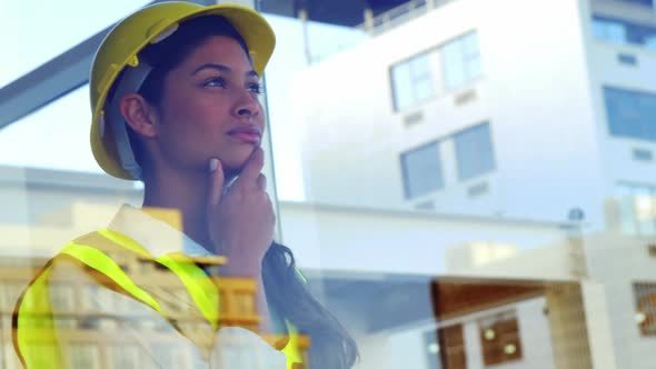 engineer looking outside window at building