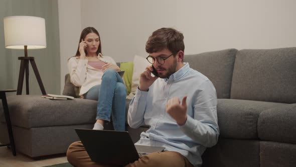 White European Man and Woman Talking on the Phone in the Room