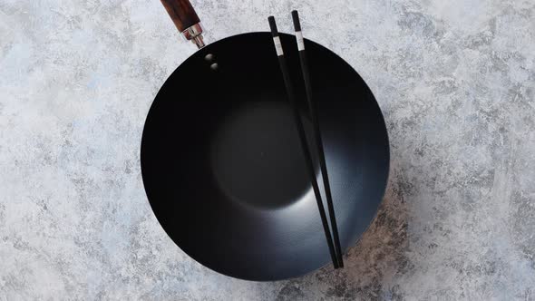 Traditional Empty Black Iron Wok Pan Placed on Stone Background