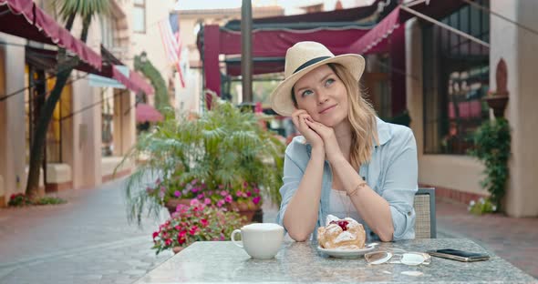 Pretty Woman Is Daydreaming in Street Restaurant at Old Historic Town in Europe