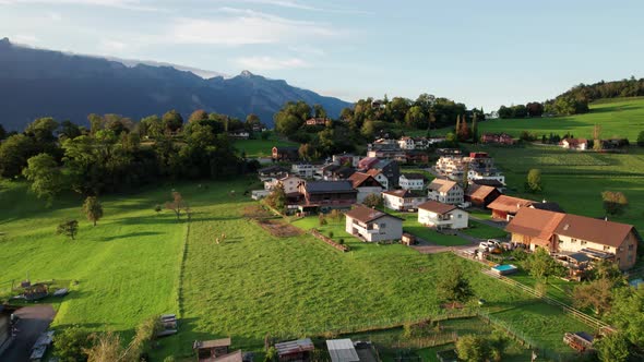 Aerial View of Liechtenstein with Houses on Green Fields in Alps Mountain Valley