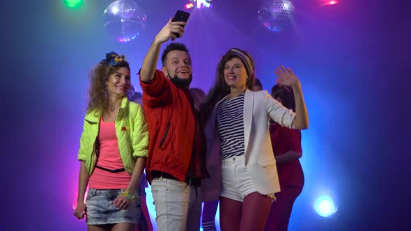 Smiling Attractive Party People Taking a Selfie at the Nightclub