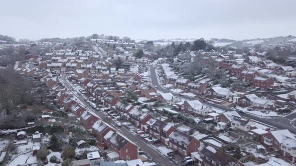 Low dolly forward drone shot of snowy Exeter subburbs CROP