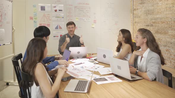 A group of multi ethnic successful business people applauding, clapping hands