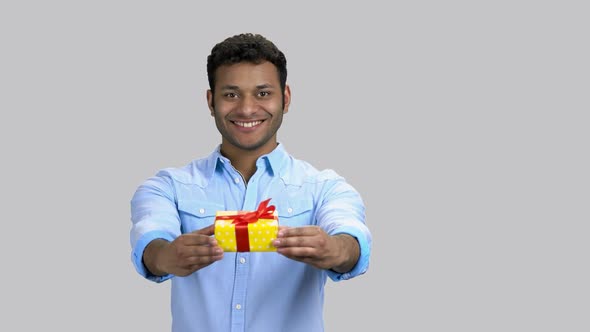 Happy Cheerful Darkskinned Guy Giving Present Gift Box