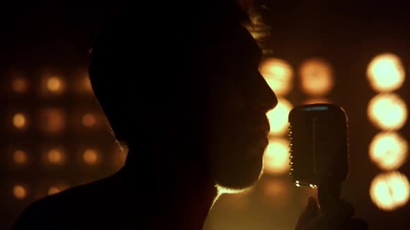 Silhouette Guy Performing Song in Nightclub Closeup