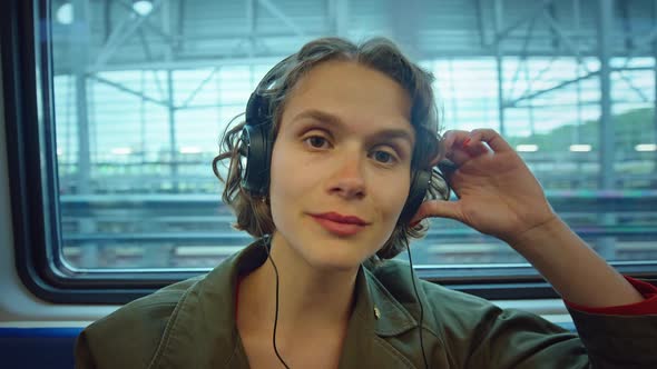 Young Candid Woman Listen to Music in Subway