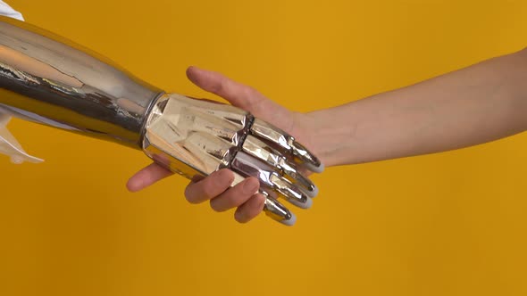 Man Shakes Hands with Person Using Shiny Bionic Arm Closeup