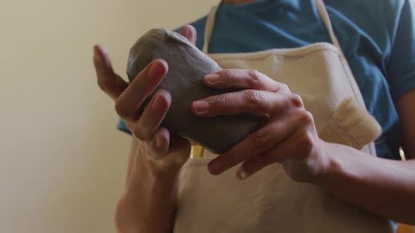 Young female potter working in her studio