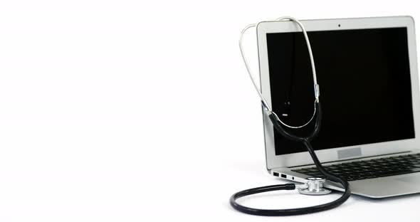 Close-up of stethoscope with laptop