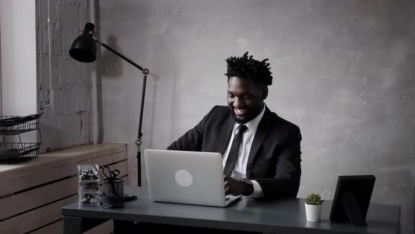 Black Business Man in Suit Holds a Video Conference Meeting