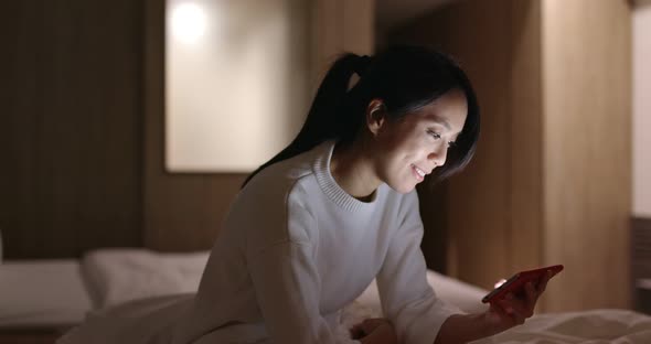 Woman watch on cellphone at home