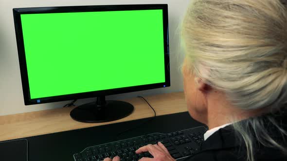 Old Caucasian Woman Works on Computer in Home - Green Screen - Closeup