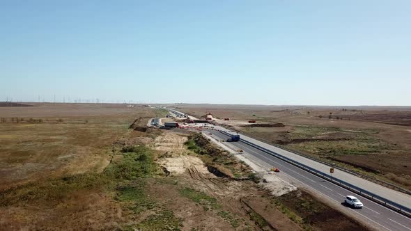 Aerial Road Constructions, Machinery and Mine Equipment Near Road on Sandy Surface alt
