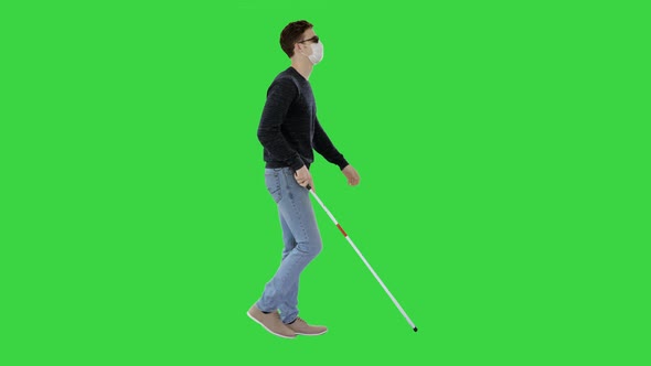 Blind Man In Medical Mask Walking on a Green Screen, Chroma Key.