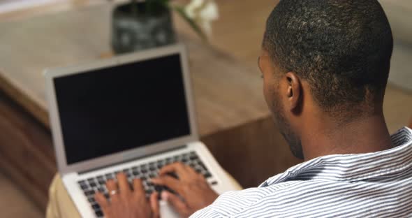 Man using laptop at home 4k