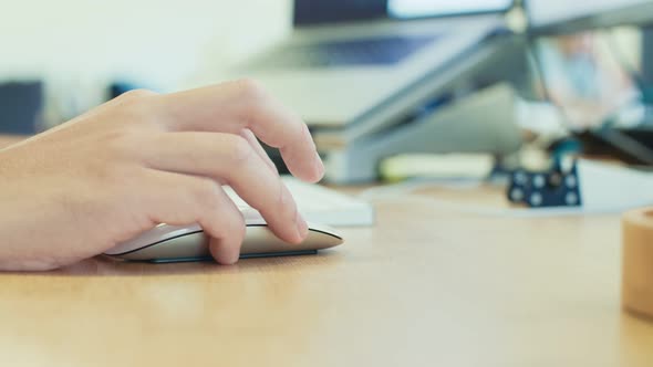 man hand working with wireless mouse on a desk