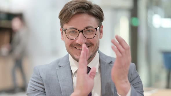 Portrait of Excited Businessman Clapping Cheering