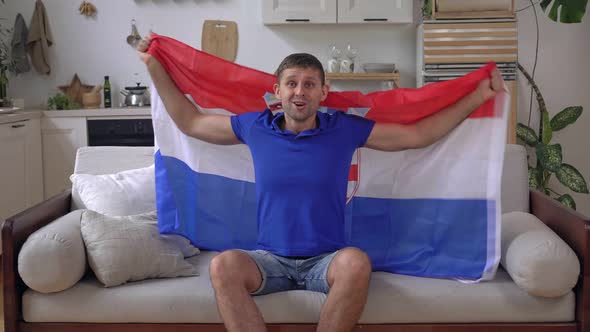 Male Sports Fan at Home with the Flag of Croatia
