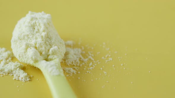 Close Up of Baby Milk Powder and Spoon on Tile Background