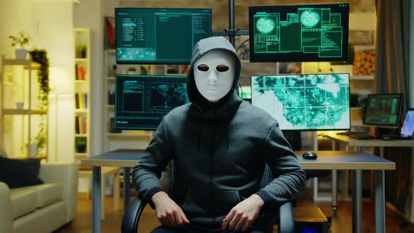 Dangerous Hacker Hiding His Identity Wearing a White Mask